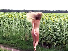 Alena posing between sunflowers