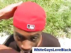 Чёрный парнишка в красной шапке делает минет белому парню