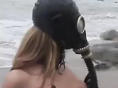 Девочка в противогазе и в чёрных сапогах подчиняется хозяину