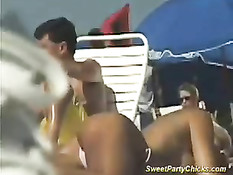 Девушки купаются и загорают на солнечном пляже в обнажённом виде