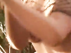 Девчонка в красных чулочках и сетчатом боди умеет дрочить ногами