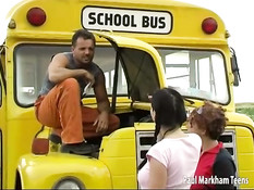 Two teen girls helping a bus driver