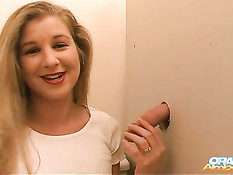 Блондиночка решила отсосать и подрочить просунутый в дыру член