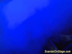 Горячая блондинка в латексном костюме танцует стриптиз на сцене