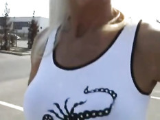 Блондинка в солнцезащитных очках на улице оголяет грудь и пизду