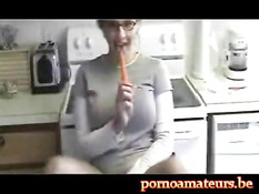 In the kitchen with a long carrot